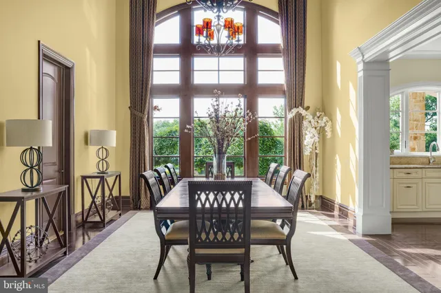 a living room with furniture a fireplace and floor to ceiling window