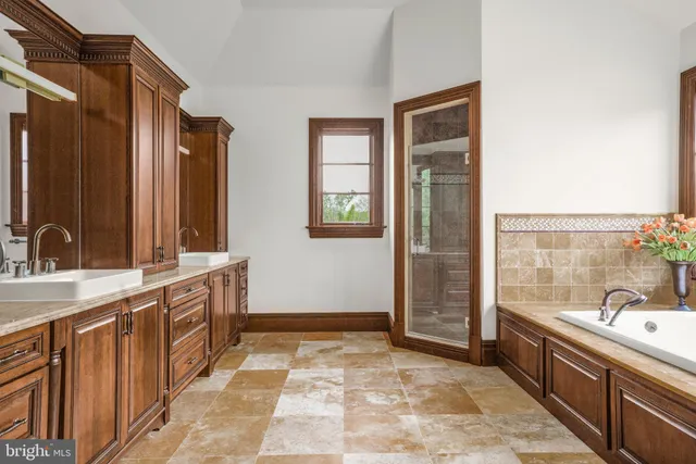 a spacious bedroom with a bed and wooden floor