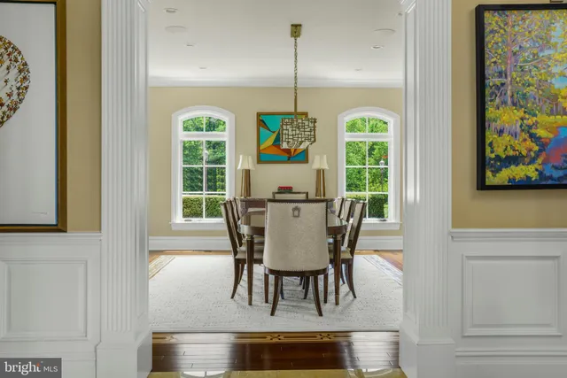a dining room with furniture a rug and a window