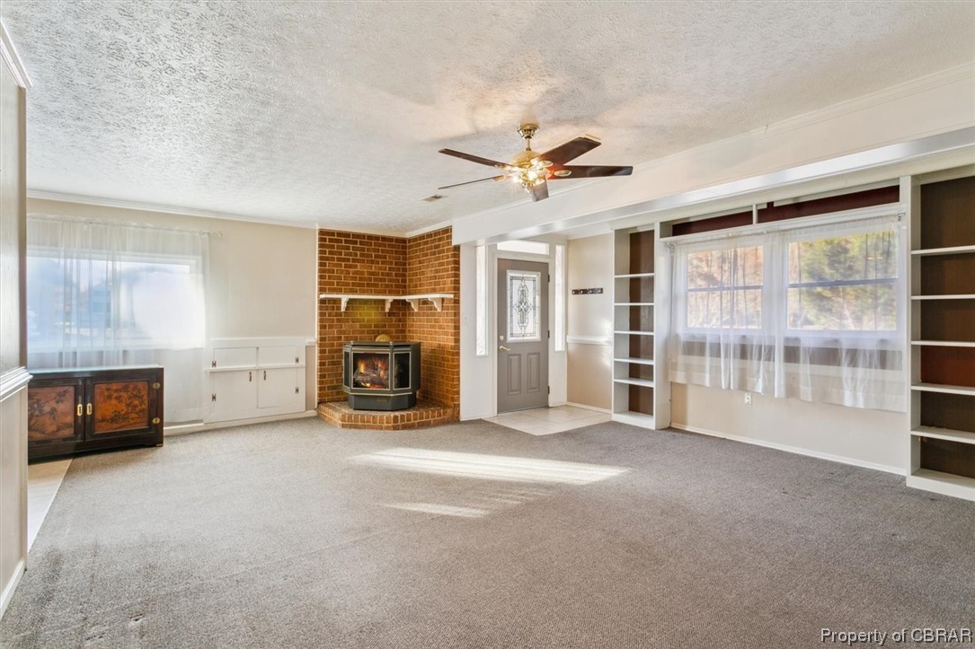 3255 Providence Road Hayes, VA 23072 - Photo 4 of 46 Living room with a gasfireplace, light carpet, ceiling fan, and a textured ceiling