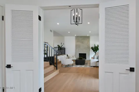 a view of a livingroom with furniture and a mirror