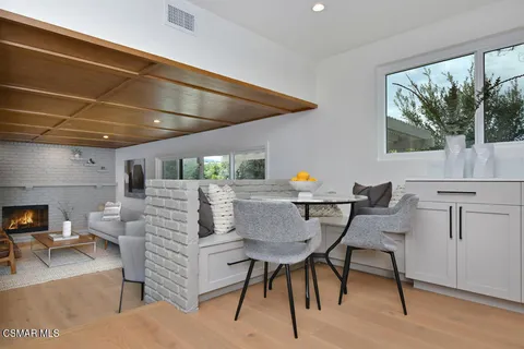 a view of a dining room with furniture window and wooden floor
