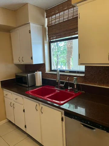 a kitchen with a sink and cabinets