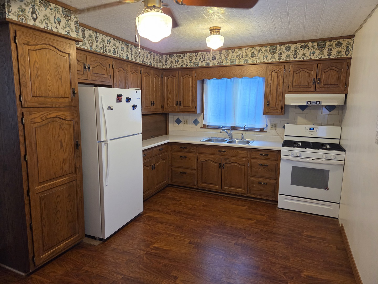 712 East Monroe Street Bloomington, IL 61701 - Photo 3 of 34 a kitchen with a refrigerator a stove a sink and cabinets