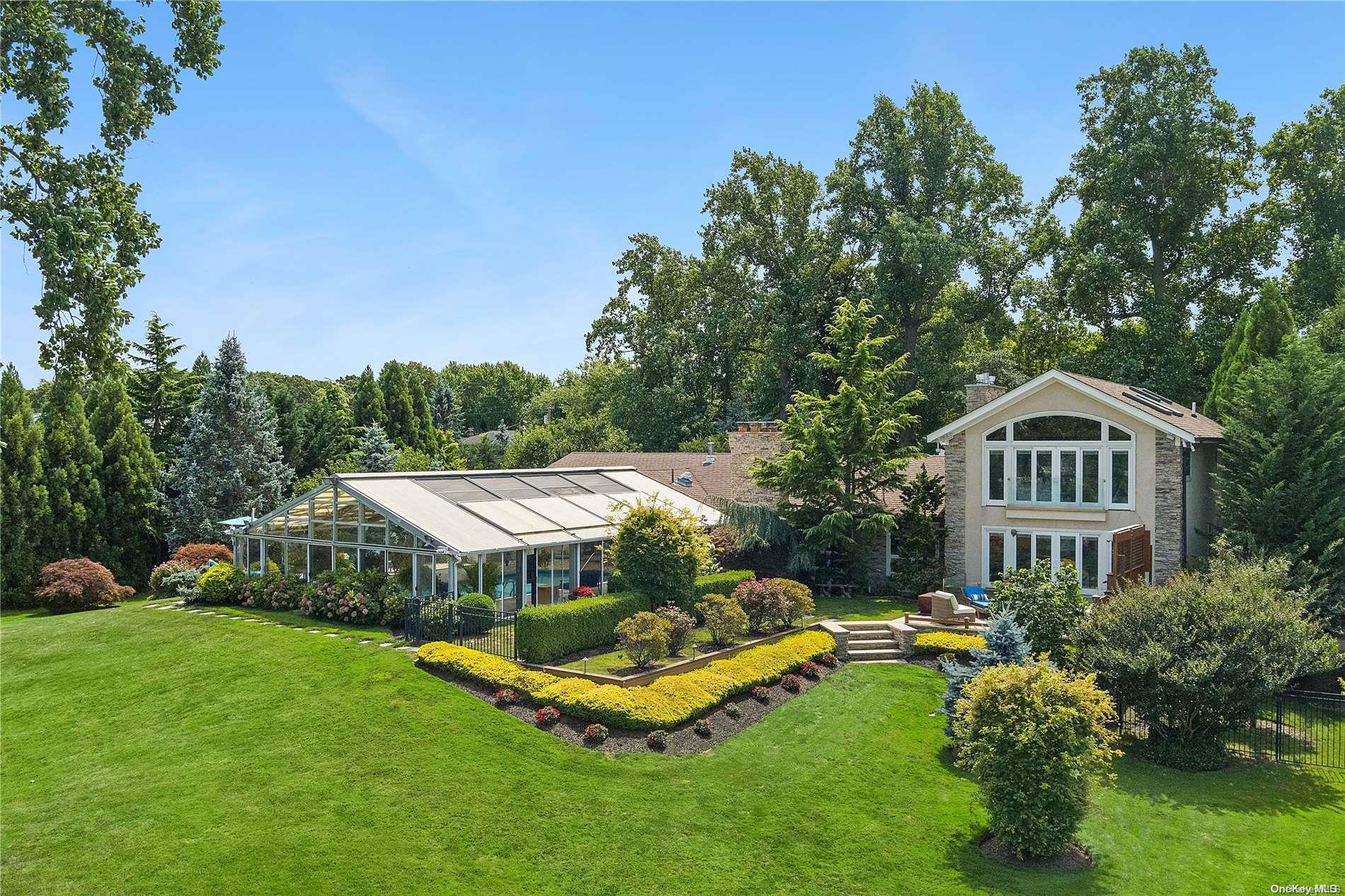 a aerial view of a house with swimming pool and garden
