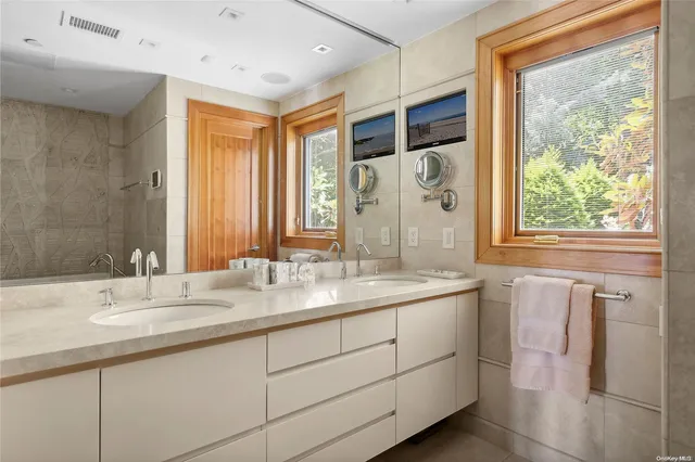 a bathroom with a granite countertop sink mirror and double