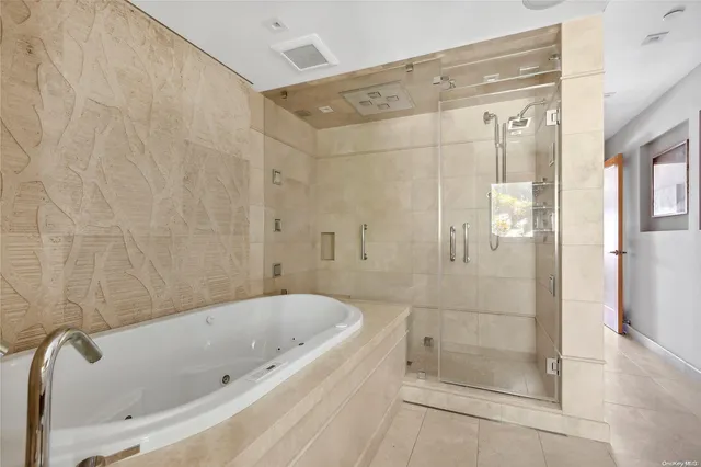 a bathroom with a bathtub and a shower