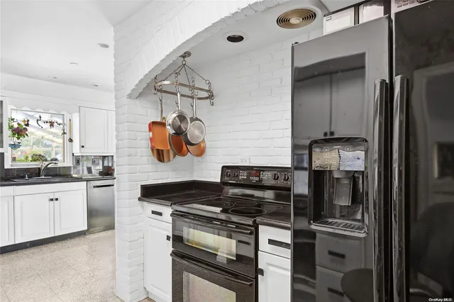 a kitchen with stainless steel appliances granite countertop a stove and a refrigerator