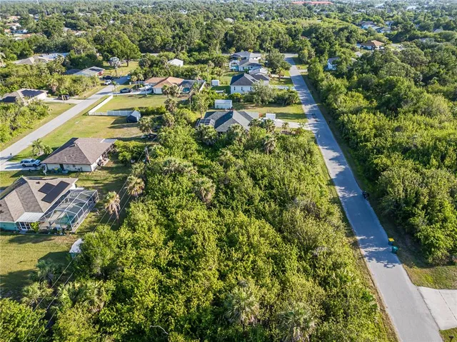 an aerial view of residential houses with yard