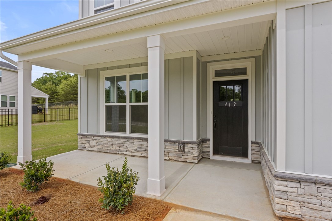 313 Old Shirley Road Central, SC 29630 - Photo 29 of 30 Welcome to a charming residence featuring a classic covered front porch and durable stone accents.