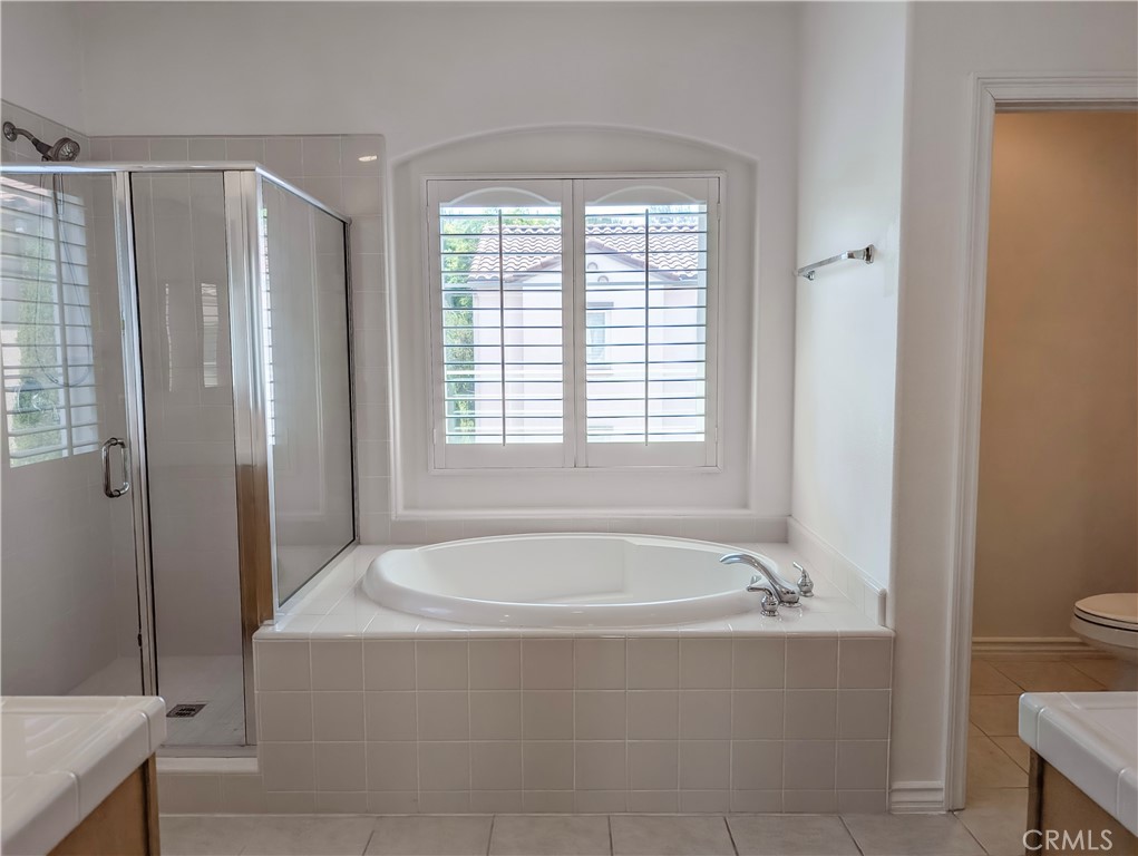 42 Blossom Irvine, CA 92620 - Photo 25 of 34 a white bath tub sitting next to a toilet