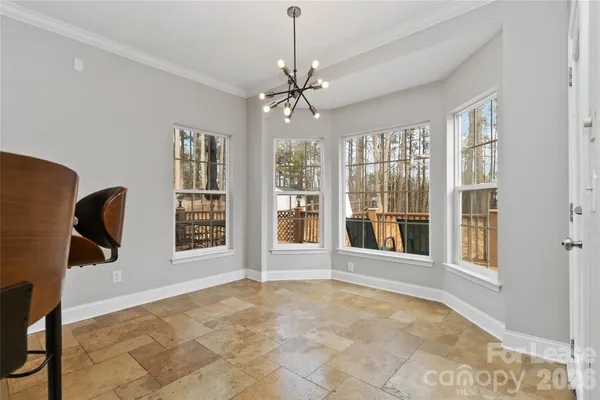 a view of an empty room with a window and bathroom