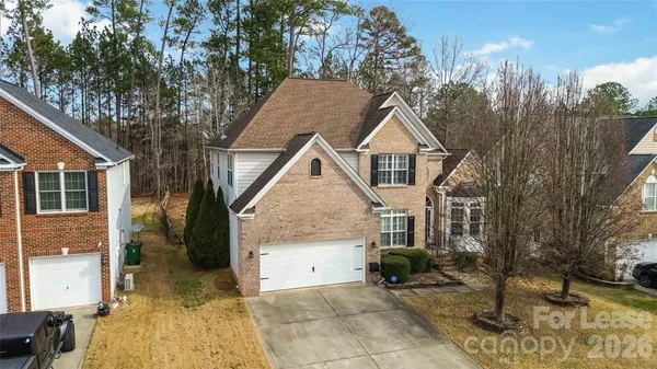 an aerial view of a house with garden space and street view