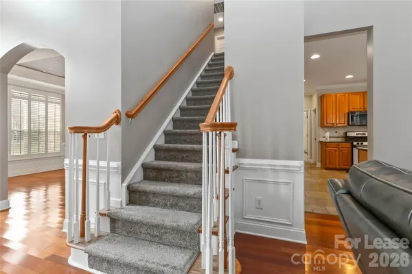 a view of entryway and hall with wooden floor