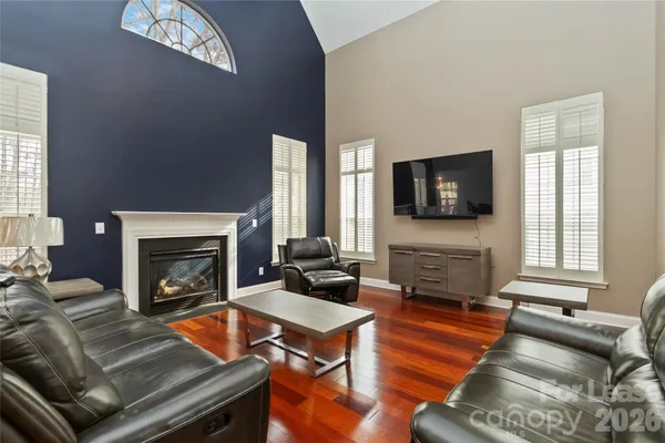 a living room with furniture a fireplace and a flat screen tv