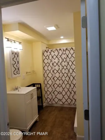 a bathroom with a sink a mirror and a shower