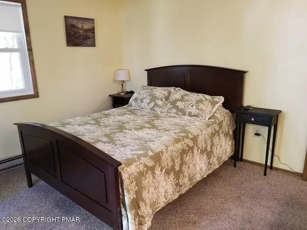 a bed sitting in a bedroom next to a window