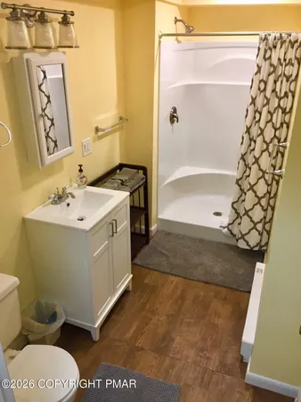a bathroom with a sink toilet and shower