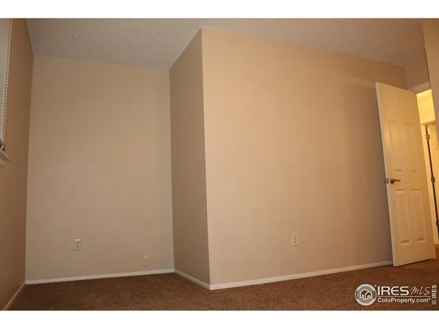 a view of a room with a ceiling fan and a window