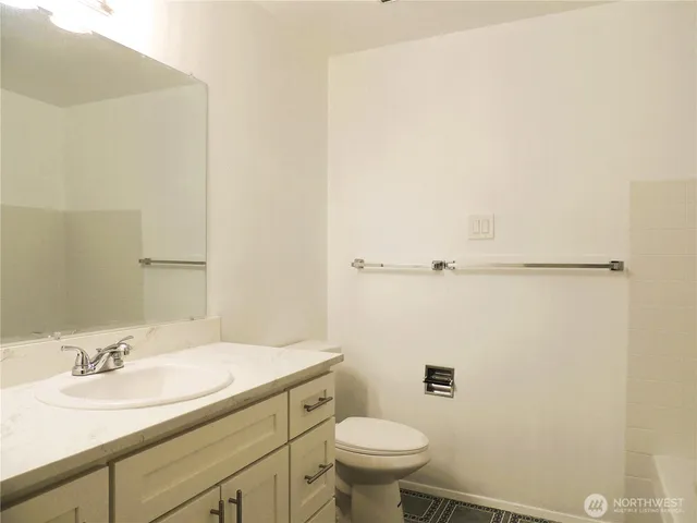 a view of an empty room with closet area