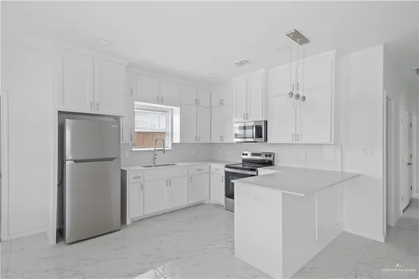 a view of a kitchen with electric appliances