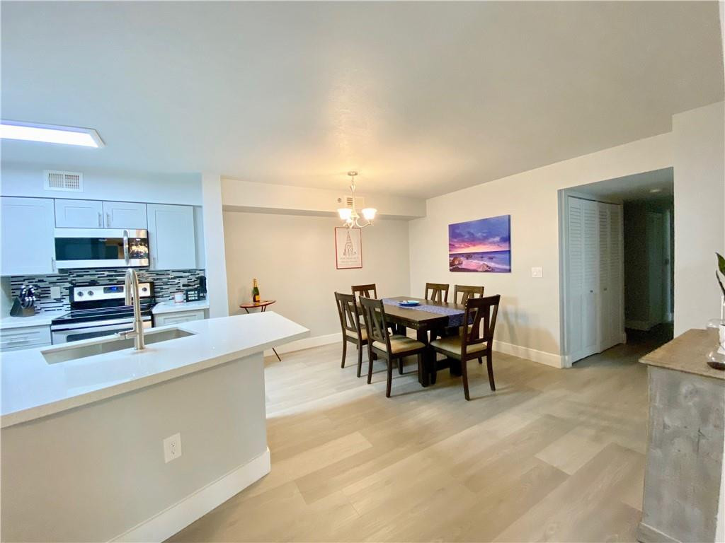 a large kitchen with a table and chairs in it