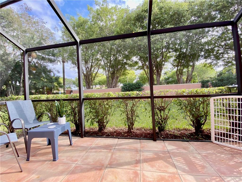 3207 Clint Moore Road, Unit 104 Boca Raton, FL 33496 - Photo 13 of 46 a view of a garden from a porch