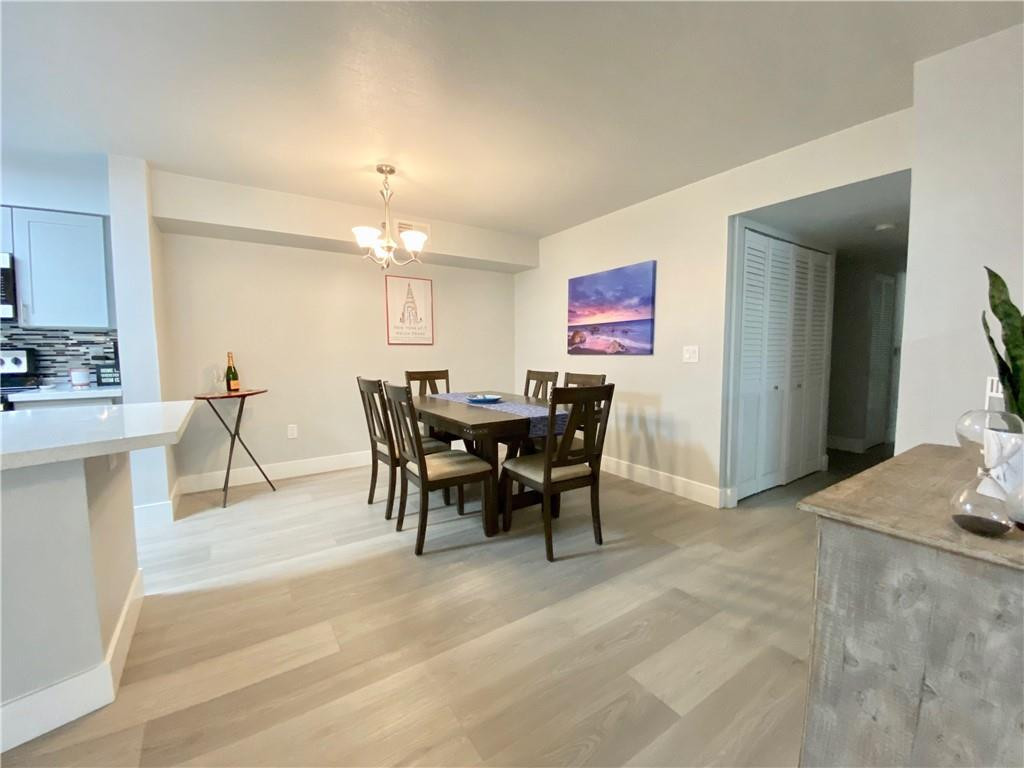 3207 Clint Moore Road, Unit 104 Boca Raton, FL 33496 - Photo 14 of 46 a view of a dining room with furniture