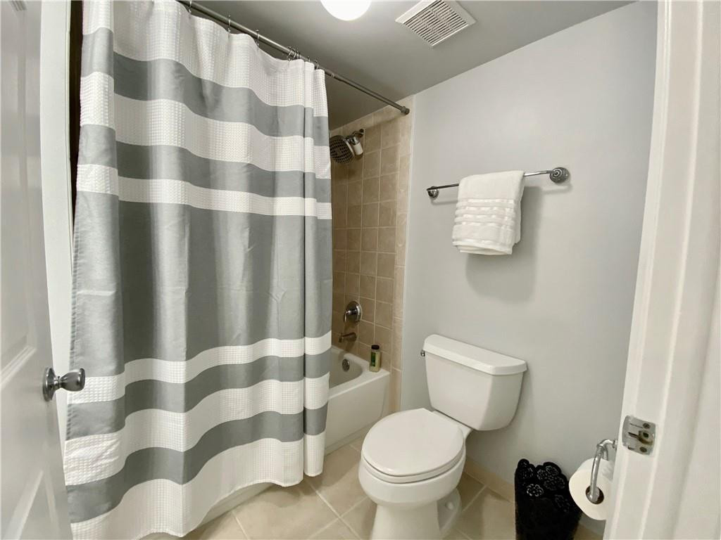 3207 Clint Moore Road, Unit 104 Boca Raton, FL 33496 - Photo 20 of 46 a bathroom with a toilet and a shower