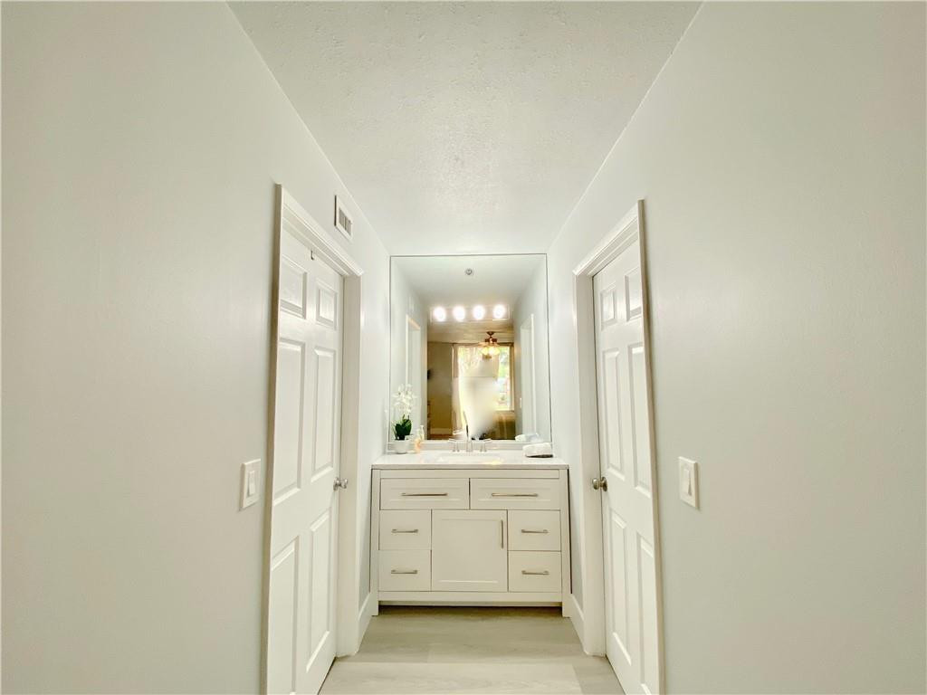 3207 Clint Moore Road, Unit 104 Boca Raton, FL 33496 - Photo 21 of 46 a bathroom with a granite countertop sink and a mirror