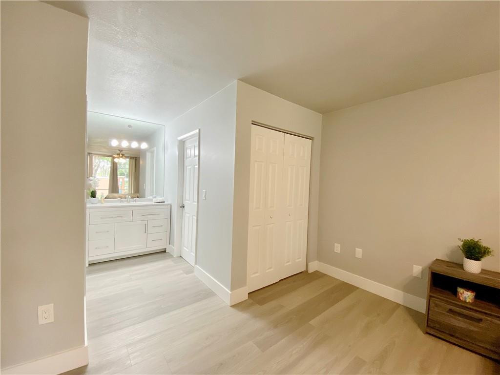3207 Clint Moore Road, Unit 104 Boca Raton, FL 33496 - Photo 22 of 46 a view of a room with cabinet and mirrors