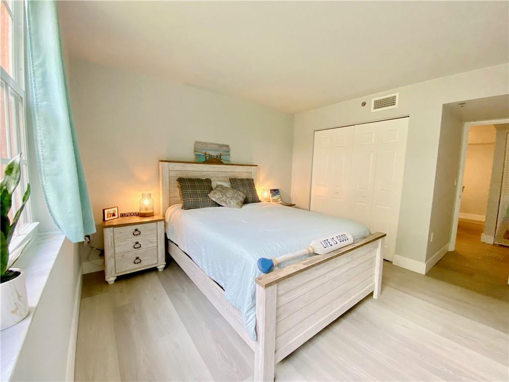 3207 Clint Moore Road, Unit 104 Boca Raton, FL 33496 - Photo 24 of 46 a bed room with a bed and a white door