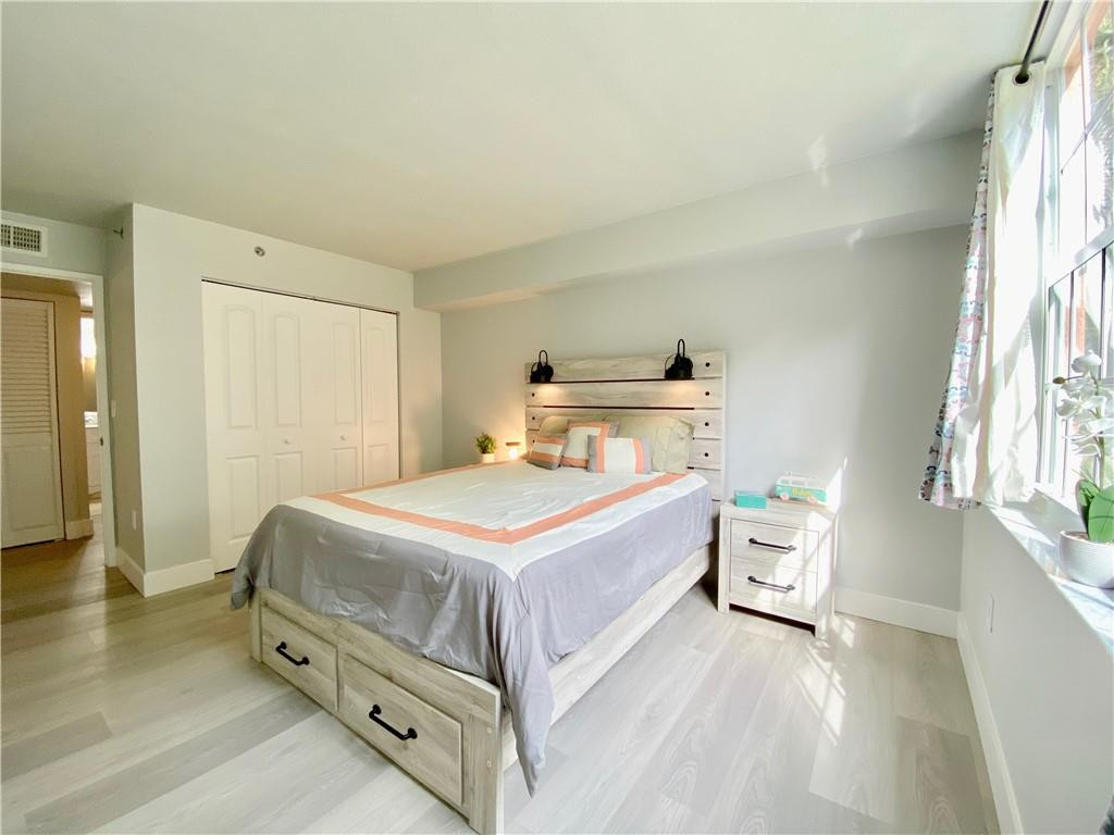 3207 Clint Moore Road, Unit 104 Boca Raton, FL 33496 - Photo 27 of 46 a bedroom with a bed and a window