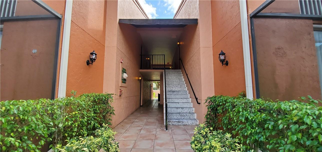 3207 Clint Moore Road, Unit 104 Boca Raton, FL 33496 - Photo 30 of 46 front view of a house with an outdoor space