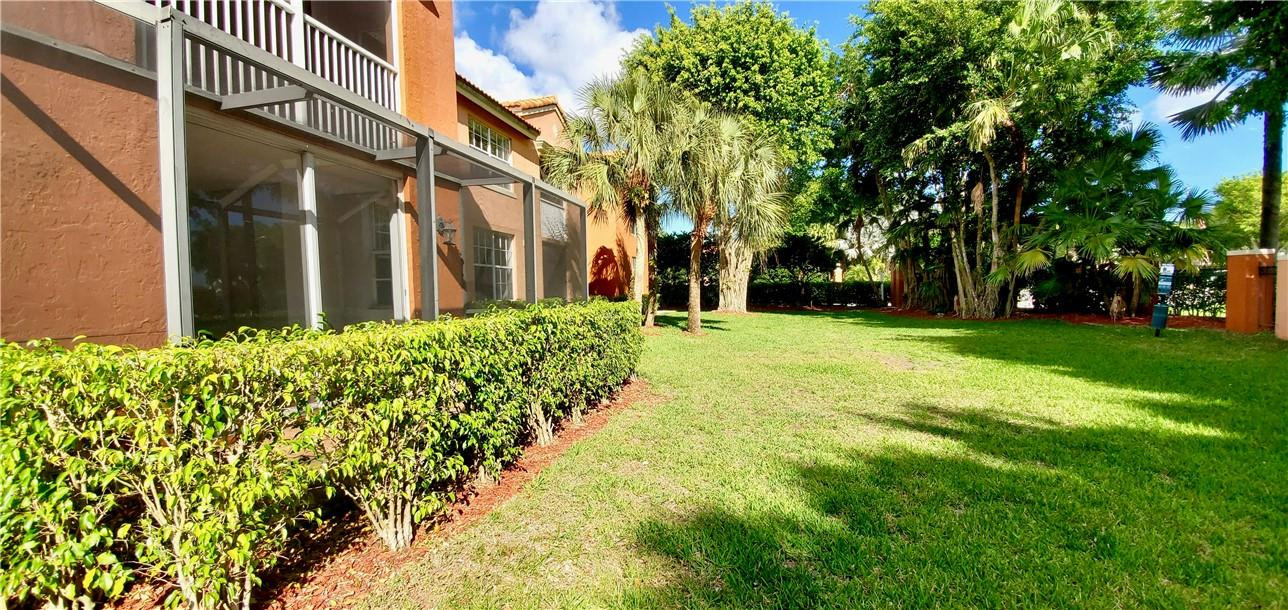 3207 Clint Moore Road, Unit 104 Boca Raton, FL 33496 - Photo 31 of 46 a view of a yard with plants and trees
