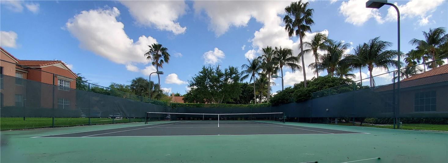 3207 Clint Moore Road, Unit 104 Boca Raton, FL 33496 - Photo 34 of 46 a view of a tennis court