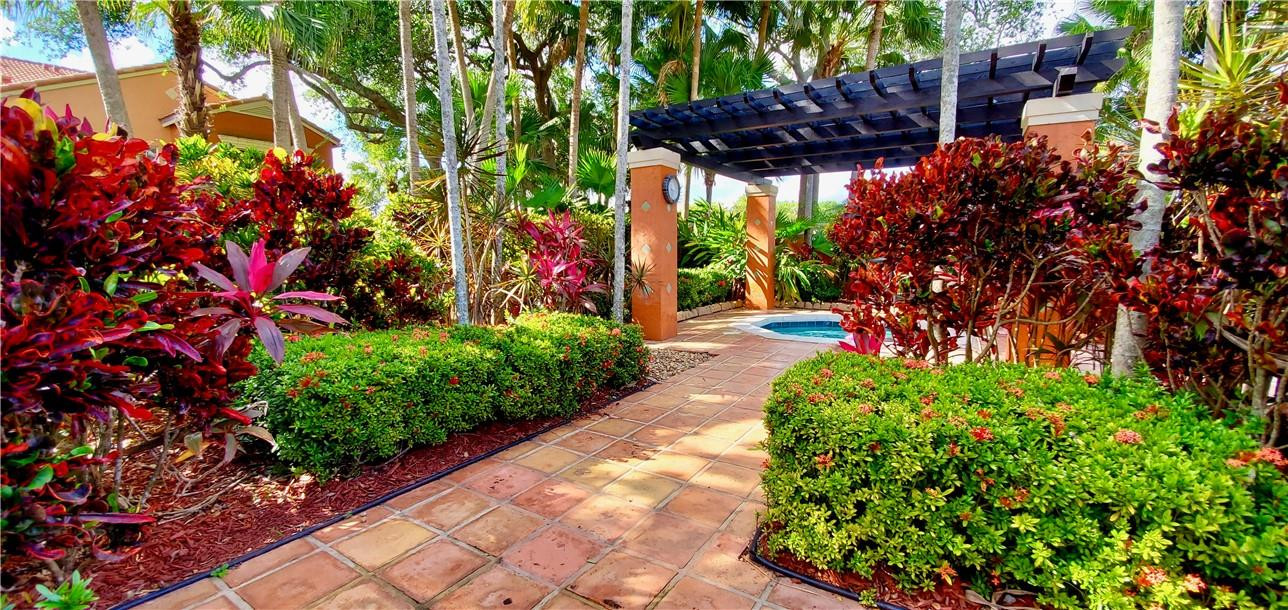 3207 Clint Moore Road, Unit 104 Boca Raton, FL 33496 - Photo 35 of 46 a view of a garden with flowers