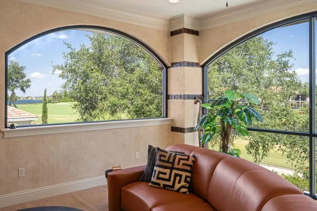 a view of a hallway with a chandelier and livingroom view
