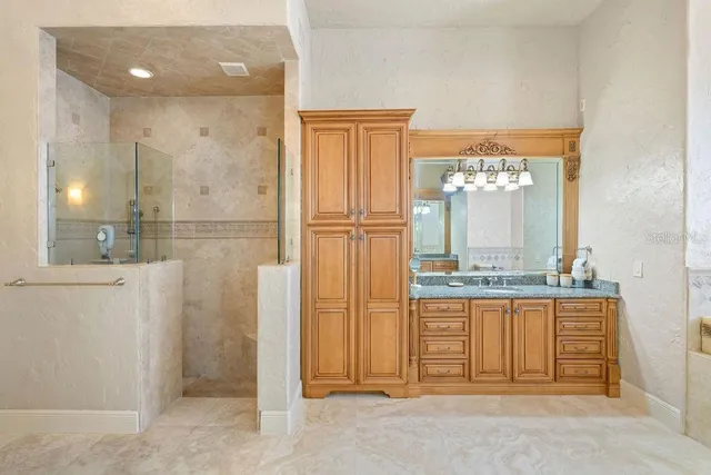 a living room with furniture a fireplace and a chandelier