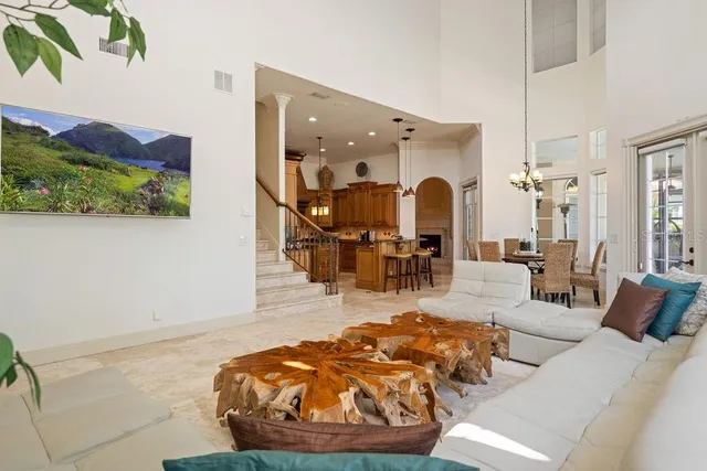 a living room with furniture and a chandelier