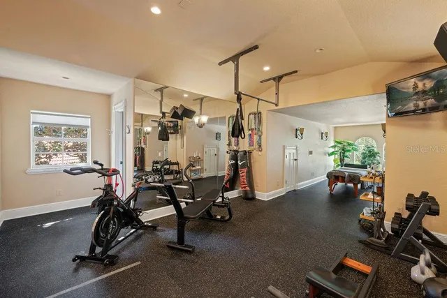 a front view of a house with a yard and potted plants