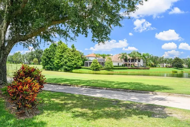 a view of a swimming pool with an outdoor seating and yard