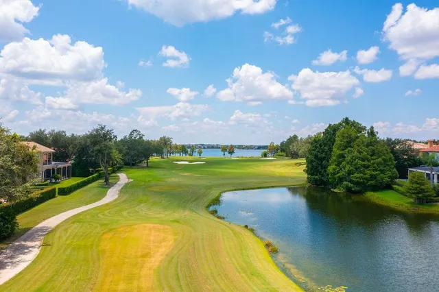 an aerial view of a house with swimming pool and outdoor seating