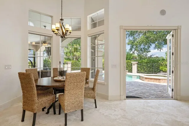 a dining room with furniture a chandelier and wooden floor