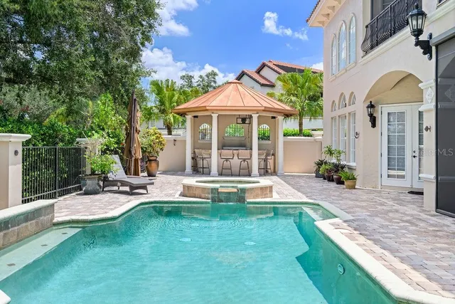 a view of a house with a yard patio and fire pit