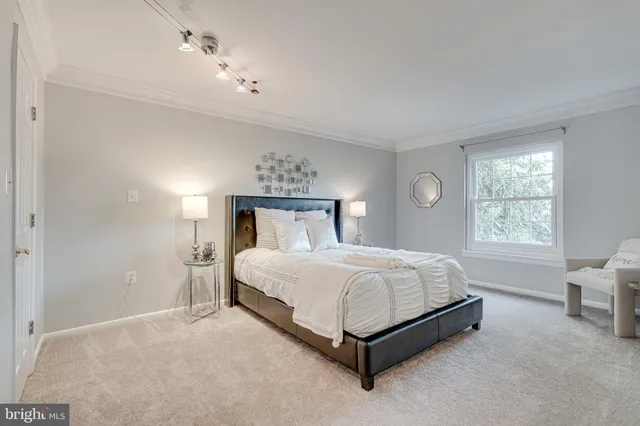 a bedroom with a bed lamp and window