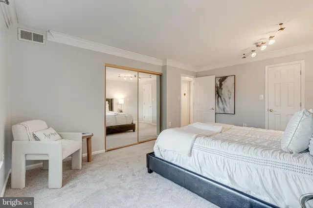 a bedroom with a bed and a chair