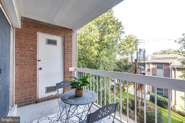 a view of a balcony with chair and potted plants