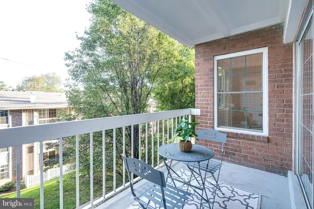 a view of a chair and table in the balcony