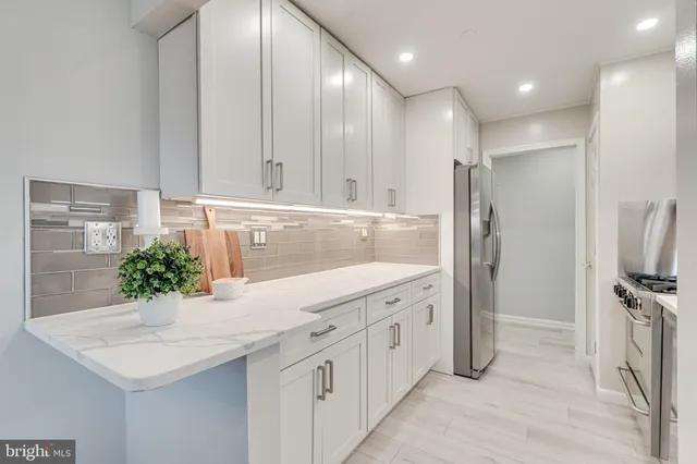 a kitchen with stainless steel appliances a sink and a refrigerator